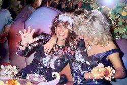 British glamour model Linda Lusardi (left) is treated to a cake fight at her birthday party, circa 1985