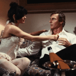 Martine Beswick and Adam West in The Happy Hooker Goes Hollywood (1980)