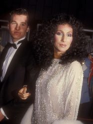 Cher wearing Bob Mackie with Val Kilmer at the 55th Academy Awards at the Dorothy Chandler Pavilion in Los Angeles on April 11, 1983.